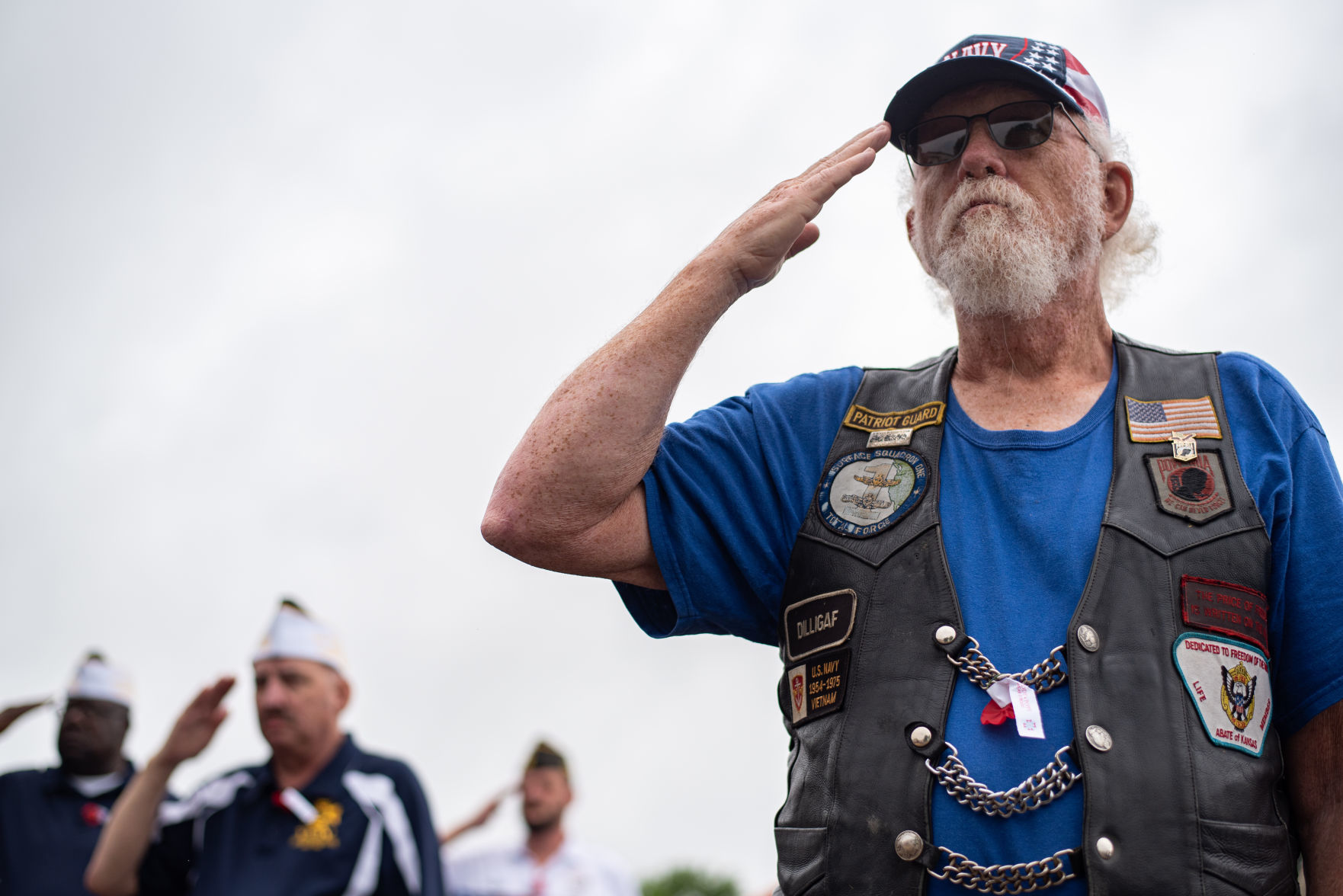Bill Padgett, Navy Veteran, salutes while taps is being played by John Lehner and Scott Freeby at Valley View Memorial Park on Memorial Day.
